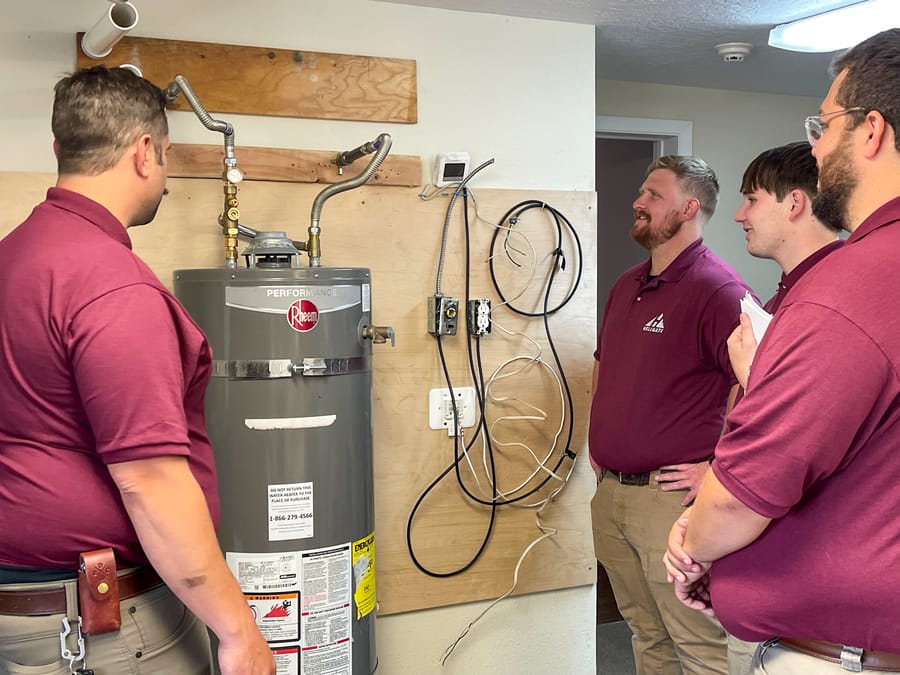 Hellgate plumbers inspecting water heater.